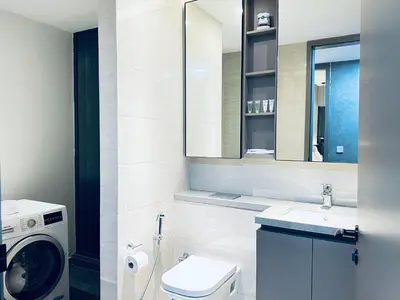 a bathroom with a sink and a washing machine at Eaton Residences By Tropika KLCC in Kuala Lumpur