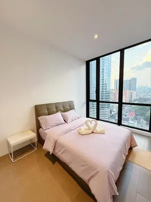 a bedroom with a large bed with two towels on it at Relax and cozy, entire unit in Kuala Lumpur