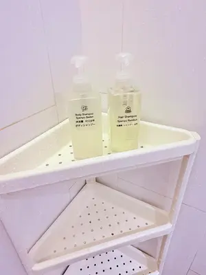 two bottles ofodorizers sitting on a shelf in a bathroom at Relax and cozy, entire unit in Kuala Lumpur