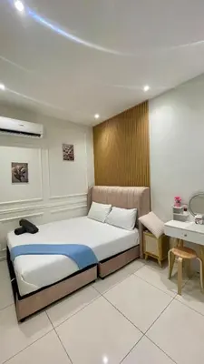 a bedroom with a bed and a table and a bed at Majestic Premium Residence Suites KLCC by Alaman in Kuala Lumpur