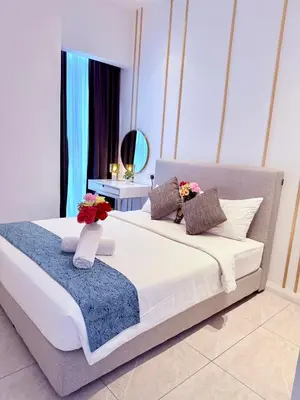 a bedroom with a large bed with flowers on it at Luxury Dream Home At Axon Residence Bukit Bintang Klcc pavilion in Kuala Lumpur