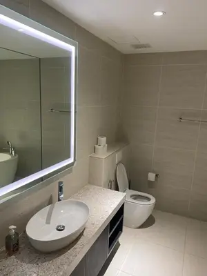 a bathroom with a sink and a toilet and a mirror at Urban Star Residence KLCC in Kuala Lumpur