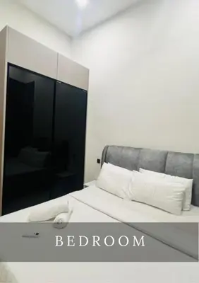 a bedroom with a bed with a large mirror at Urban Star Residence KLCC in Kuala Lumpur