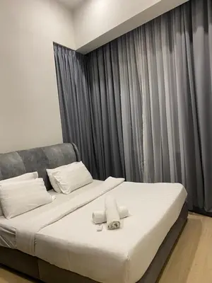 a bed with two towels on it in a bedroom at Urban Star Residence KLCC in Kuala Lumpur
