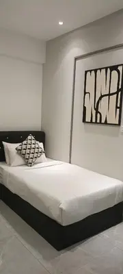 a bedroom with a large bed in a room at Elite Suites at Agile Bukit Bintang Kuala Lumpur in Kuala Lumpur