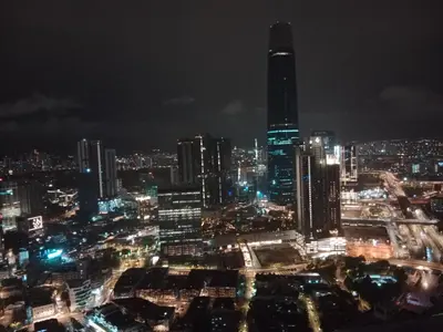 a city skyline at night with a tall building at Realty Services Suites at Berjaya Times Square in Kuala Lumpur