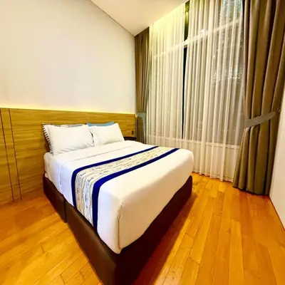a bedroom with a bed and a large window at Sky klcc by DMK luxury suites Apartment in Kuala Lumpur