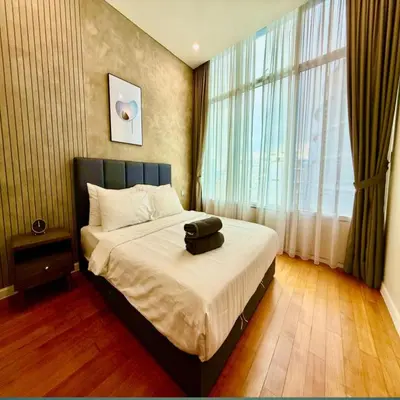 a bedroom with a bed and a large window at Sky klcc by DMK luxury suites Apartment in Kuala Lumpur