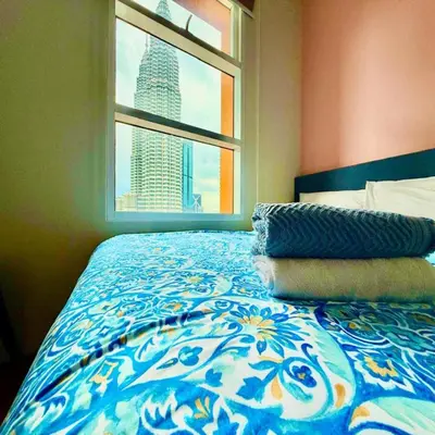 a bedroom with a bed with a view of a city at Sky klcc by DMK luxury suites Apartment in Kuala Lumpur