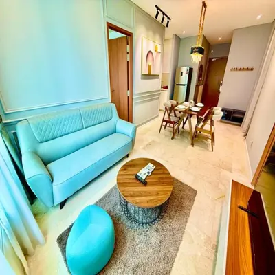 a living room with a blue couch and a table at Sky klcc by DMK luxury suites Apartment in Kuala Lumpur
