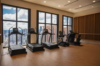 a gym with exercise equipment in a building with windows at Glowing Star Home Infinity Swimming Pool By Lalaport in Kuala Lumpur