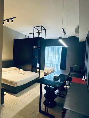 a bedroom with a bed and a desk and a table at Luxury Residence At Axon in Kuala Lumpur