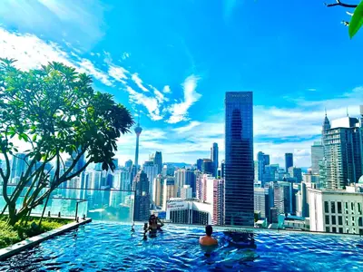 a infinity pool with a view of a city at Luxury Residence At Axon in Kuala Lumpur