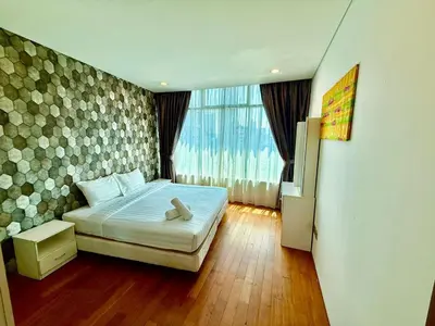 a bedroom with a bed and a large window at Vortex klcc by DMK Luxury suites Apartment in Kuala Lumpur