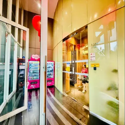 a person walking through a store looking into a window at Vortex klcc by DMK Luxury suites Apartment in Kuala Lumpur