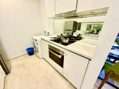 a kitchen with a stove top oven next to a dishwasher at Vortex klcc by DMK Luxury suites Apartment in Kuala Lumpur