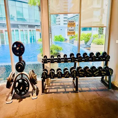 a bench in a gym with dumbbells at Vortex klcc by DMK Luxury suites Apartment in Kuala Lumpur