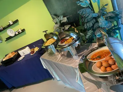 a buffet with several plates of food on a table at Melange Boutique Hotel Bukit Bintang in Kuala Lumpur