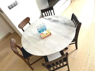 a white table with chairs and a table with bottles on it at Star Residences Suites Home in Kuala Lumpur