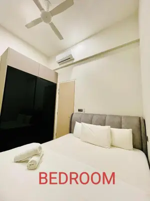 a bedroom with a bed with a ceiling fan at Star Residences Suites Home in Kuala Lumpur