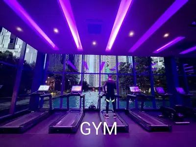 a man standing in a gym with purple lighting at Star Residences Suites Home in Kuala Lumpur