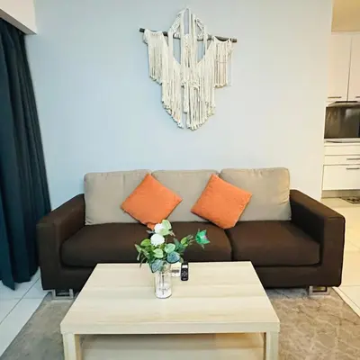 a living room with a couch and a coffee table at LuxeHive Stay in Kuala Lumpur