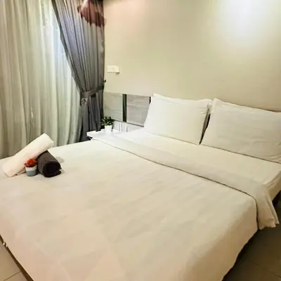 a bedroom with a large white bed and a window at LuxeHive Stay in Kuala Lumpur