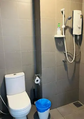 a bathroom with a toilet and a shower at LuxeHive Stay in Kuala Lumpur
