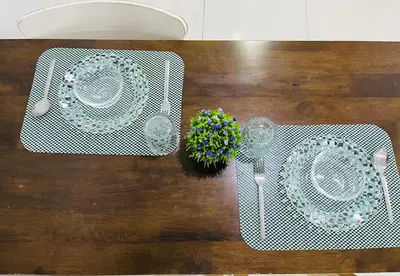 a wooden table with two plates and a table at LuxeHive Stay in Kuala Lumpur