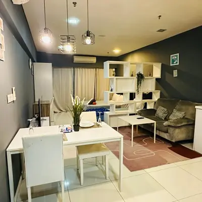 a living room with a table and a couch at LuxeHive Stay in Kuala Lumpur
