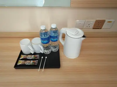 a counter with two bottles of water and a plate of food at City Comfort Hotel Kuala Lumpur City Center (Bukit Bintang) in Kuala Lumpur
