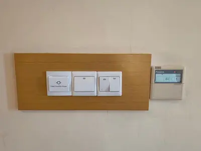 a shelf on a wall with three electrical switches at City Comfort Hotel Kuala Lumpur City Center (Bukit Bintang) in Kuala Lumpur