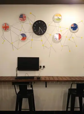 a wall with a clock and planets on the wall at Revopackers Beds and Bunks in Kuala Lumpur