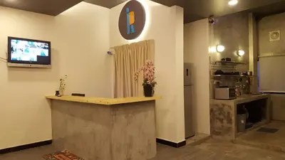 a lobby with a counter with a tv on a wall at Revopackers Beds and Bunks in Kuala Lumpur
