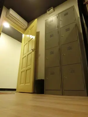 an empty room with a door and a closet with lockers at Revopackers Beds and Bunks in Kuala Lumpur