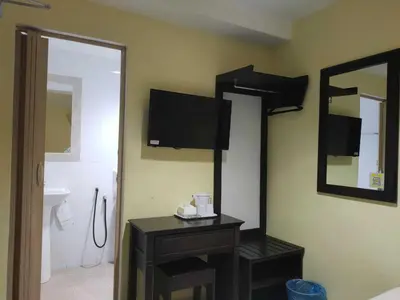 a bathroom with a tv on the wall and a mirror at Sun Inns Hotel Sentral, Brickfields in Kuala Lumpur