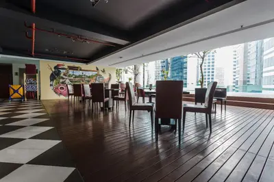 a dining room with tables and chairs and a checkered floor at Verdant Hill Hotel Kuala Lumpur in Kuala Lumpur