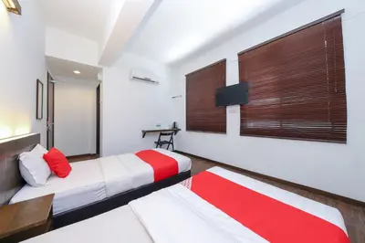 a bedroom with a bed with a red and white blanket at Hotel O Madras in Kuala Lumpur