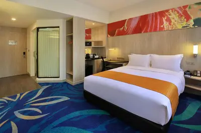 a hotel room with a large bed and a kitchen at Holiday Inn Express Kuala Lumpur City Centre by IHG in Kuala Lumpur