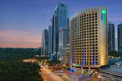 a large building in a city with tall buildings at Holiday Inn Express Kuala Lumpur City Centre by IHG in Kuala Lumpur