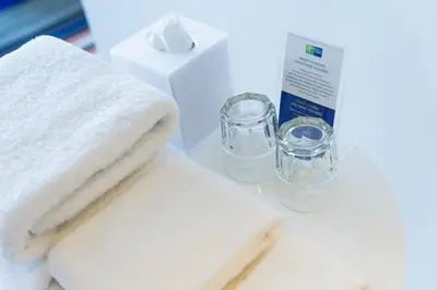 a pile of towels and a bottle and a box at Holiday Inn Express Kuala Lumpur City Centre by IHG in Kuala Lumpur