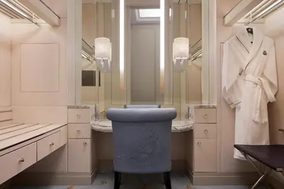 a bathroom with a blue stool in front of a mirror at The St. Regis Kuala Lumpur in Kuala Lumpur