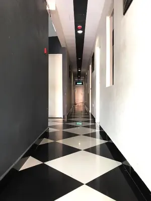 a hallway with a black and white checkered floor at Adamson Park Kuala Lumpur in Kuala Lumpur