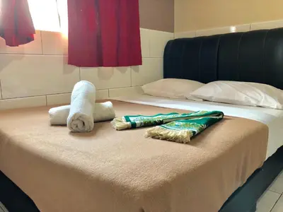 a bed with two towels and a stuffed animal on it at Adamson Park Kuala Lumpur in Kuala Lumpur