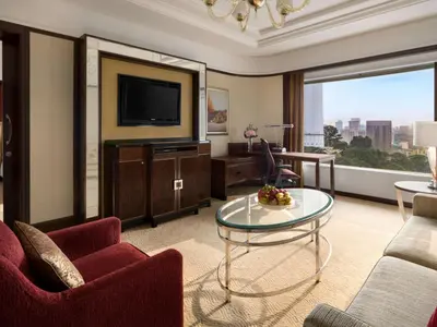 a large living room with a television and a table at Shangri-La Kuala Lumpur in Kuala Lumpur