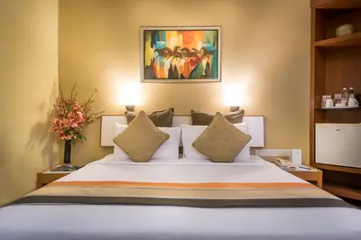 a bedroom with a large white bed with pillows at Hotel Sentral Kuala Lumpur at KL Sentral Station in Kuala Lumpur
