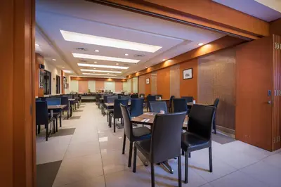 a dining room with tables and chairs in a room at Hotel Sentral Kuala Lumpur at KL Sentral Station in Kuala Lumpur