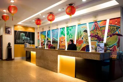 a restaurant with a counter with people sitting at it at Hotel Sentral Kuala Lumpur at KL Sentral Station in Kuala Lumpur