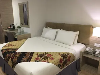a bed in a hotel room with a phone on it at NU Hotel @ KL Sentral in Kuala Lumpur