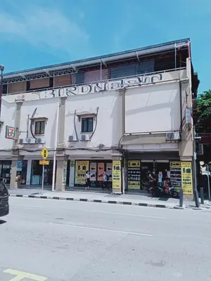 a building on the side of a street at Birdnest Guesthouse, Gaia Rooftop Cafe in Kuala Lumpur